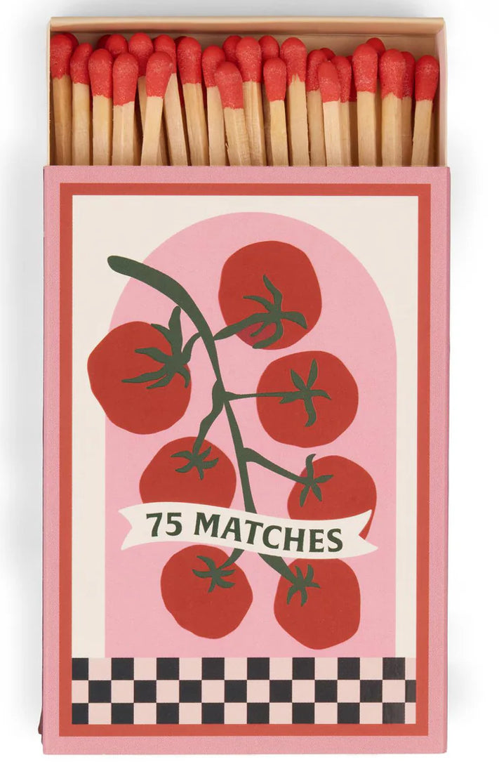 Matchbox with tomato design and '75 Matches' text on a pink background