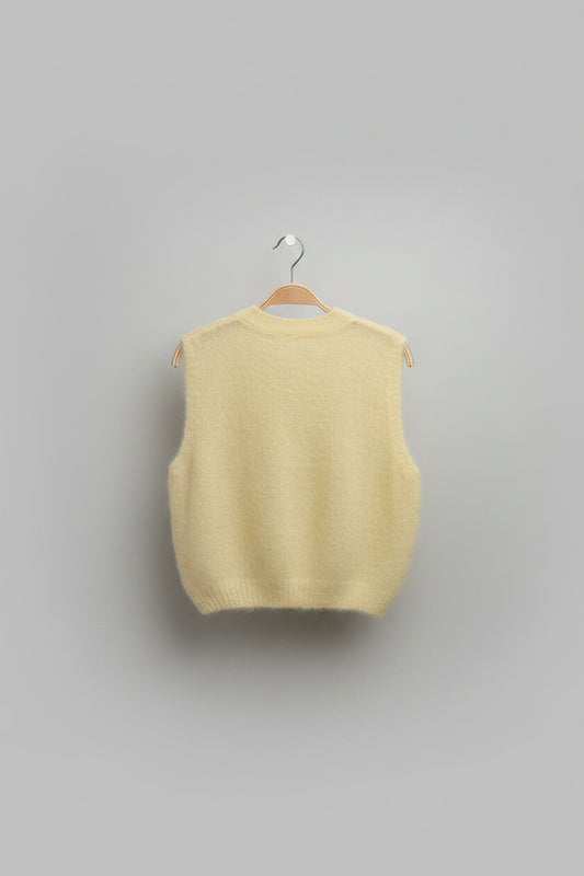 Light-coloured sweater on a hanger against a plain background