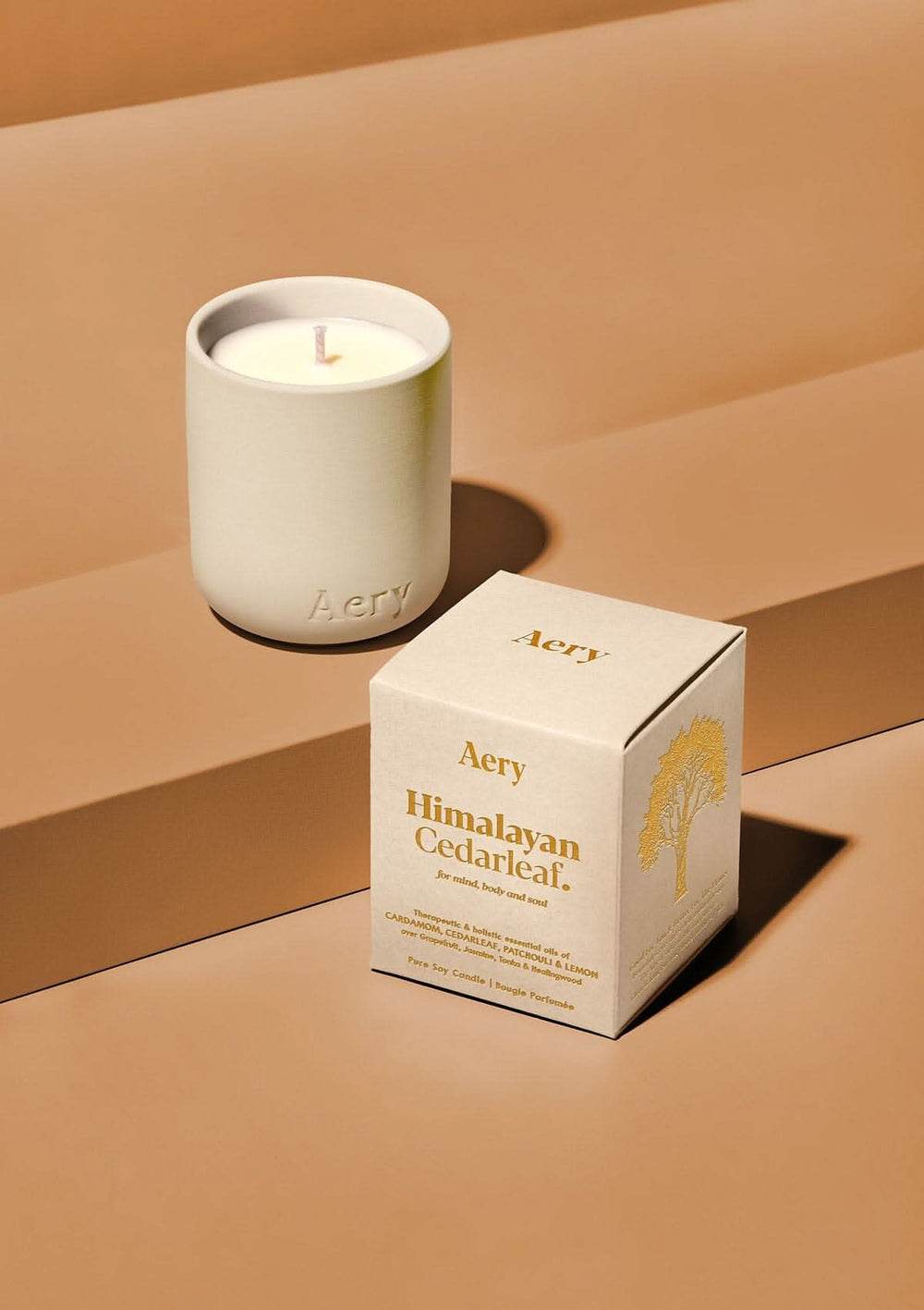 Aery Himalayan Cedarleaf Votive Candle. Aery candle and its packaging on a beige background