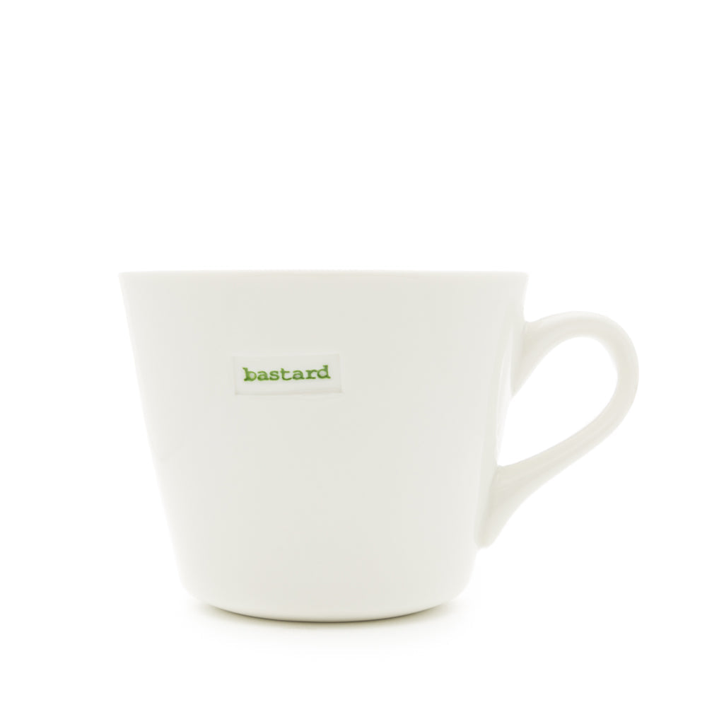 White mug with green text 'b*****d' on a white background