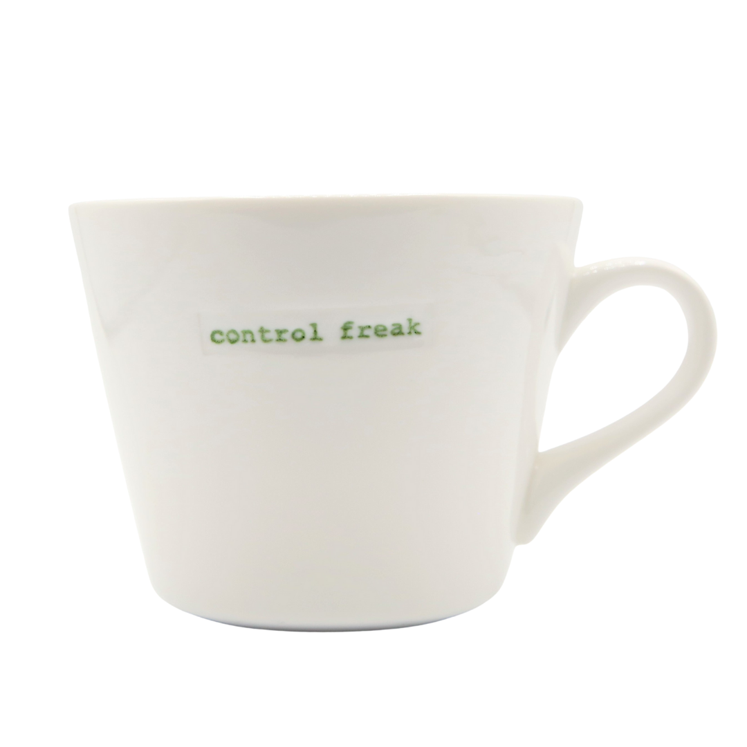 White mug with 'control freak' text in green on a white background