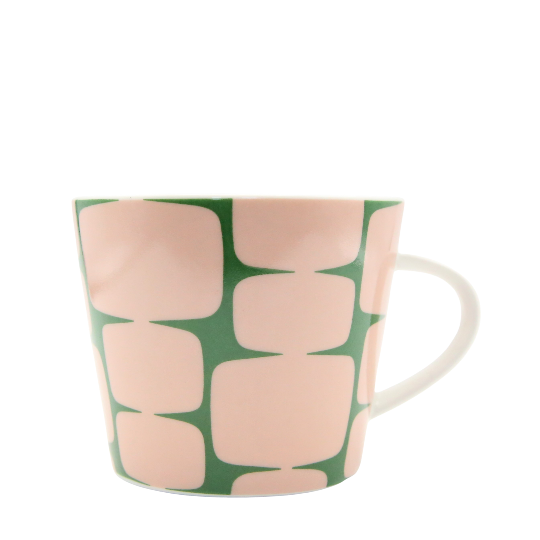 Mug with pink and green abstract pattern on a white background