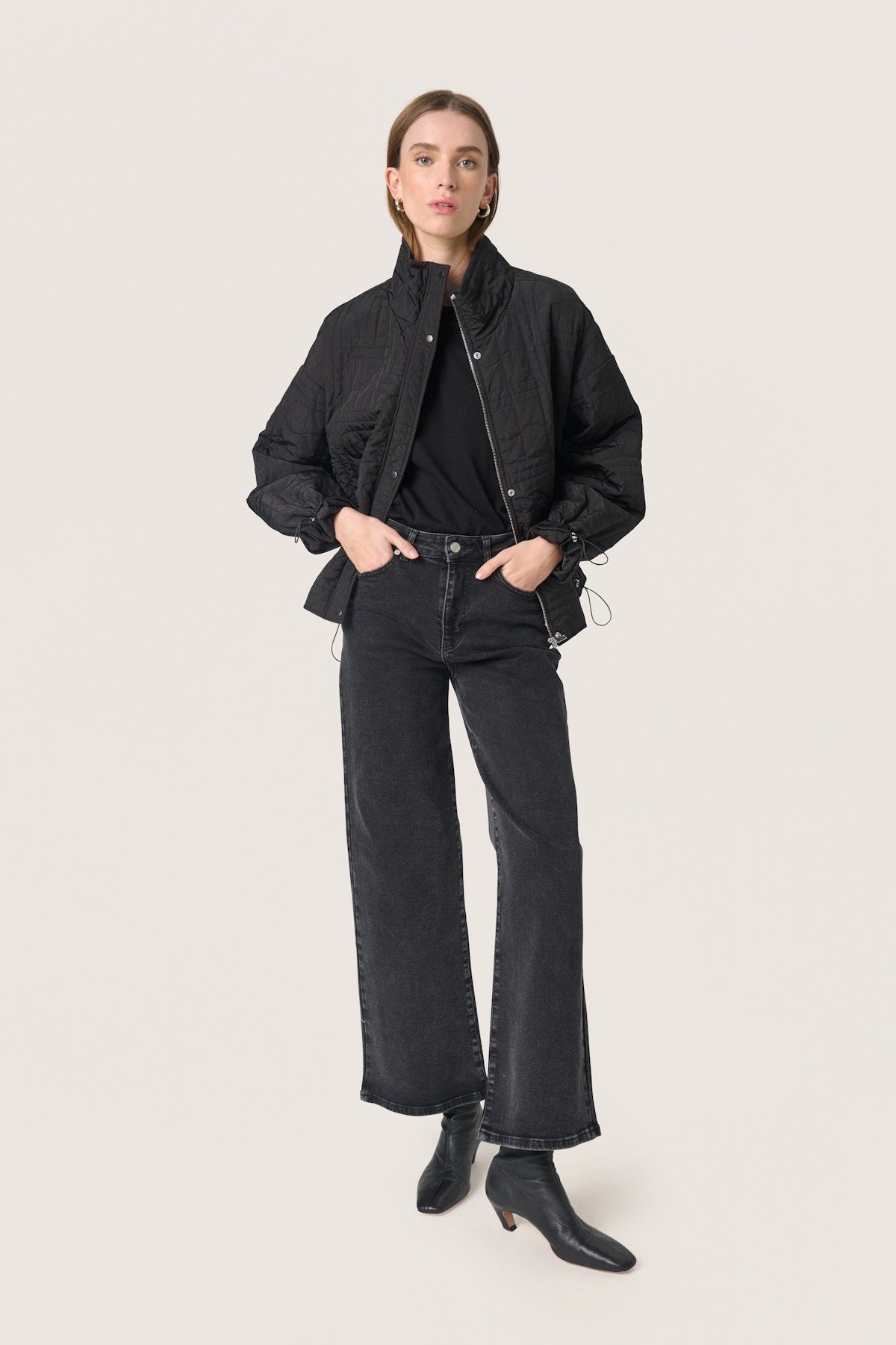 Soaked in Luxury Jackline Short Jacket in Black. Person wearing a black outfit with a jacket, shirt, and jeans on a white background