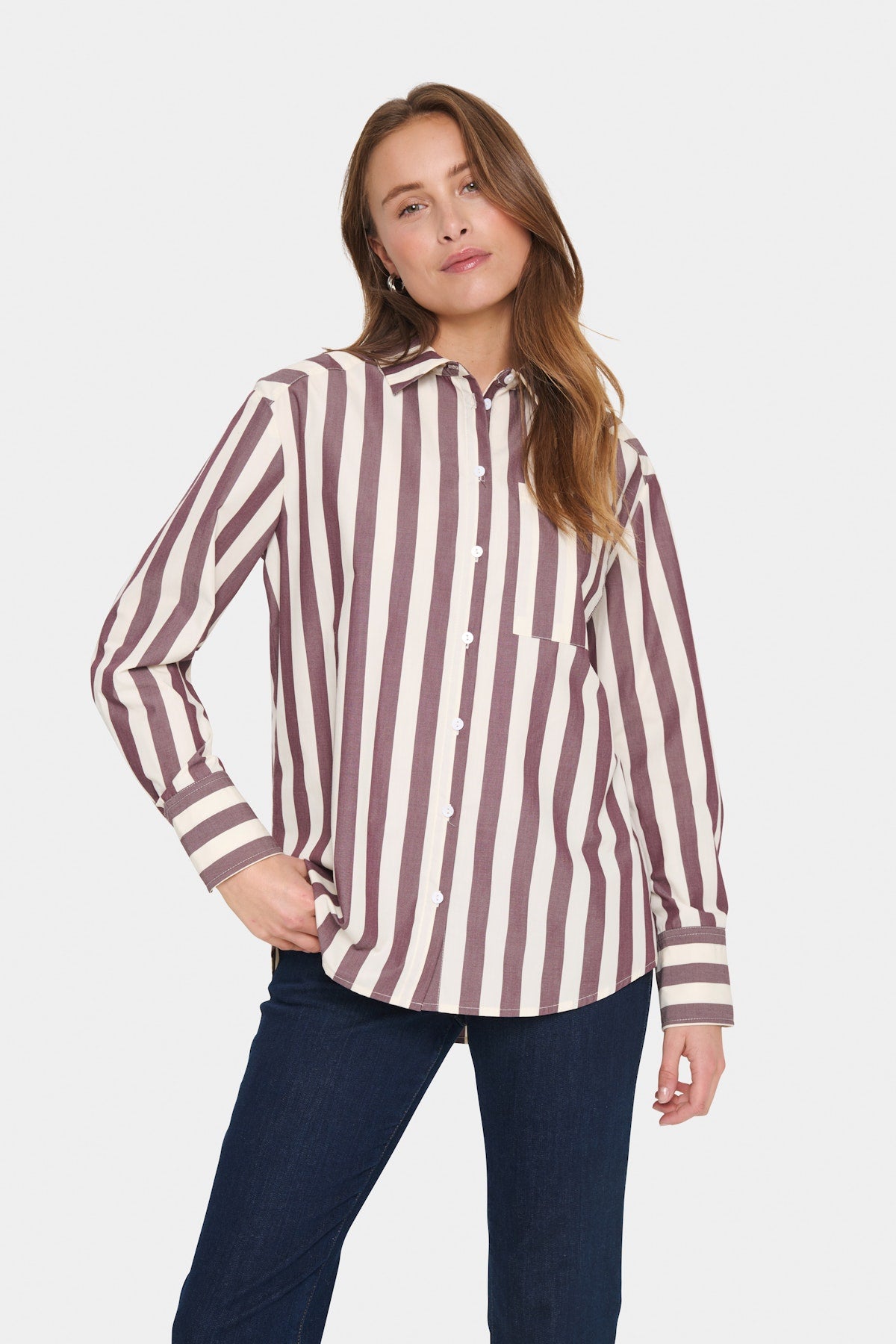 Soaked in Luxury Lieke Shirt in Decadent Chocolate Ice - Woman wearing a striped shirt and dark pants on a white background