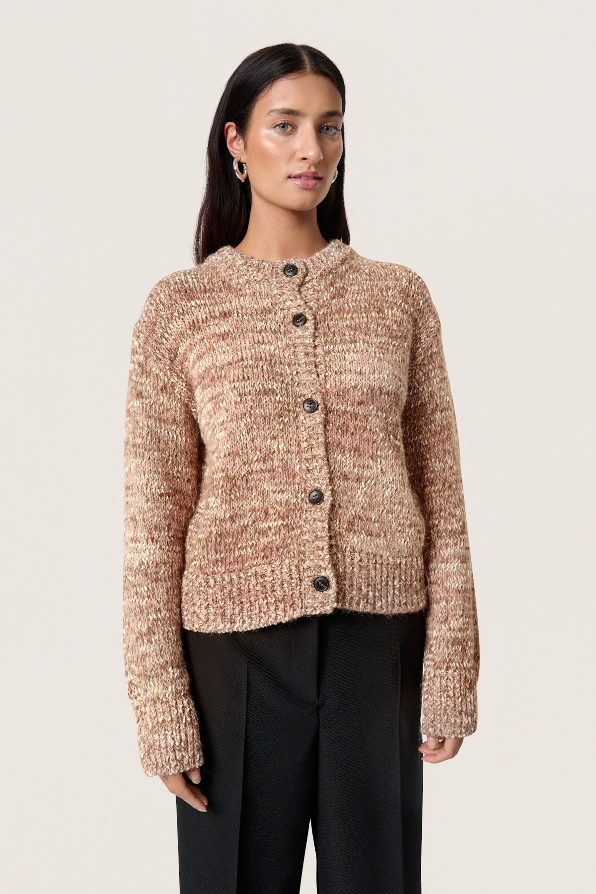 Soaked in Luxury Macawi Cardigan. Woman wearing a beige knitted cardigan on a plain background