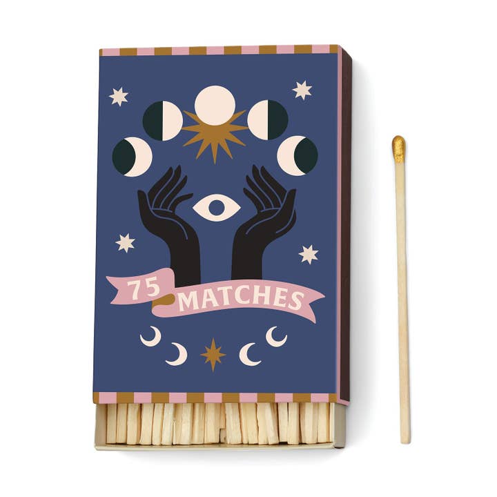 Matchbox with astrological design and matchstick on a white background
