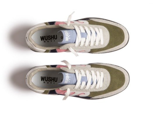 Pair of green sneakers with floral patterns and white laces on a white background