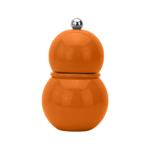 Orange pepper grinder with a silver top on a white background