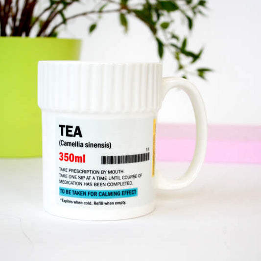White mug with tea label on a white background