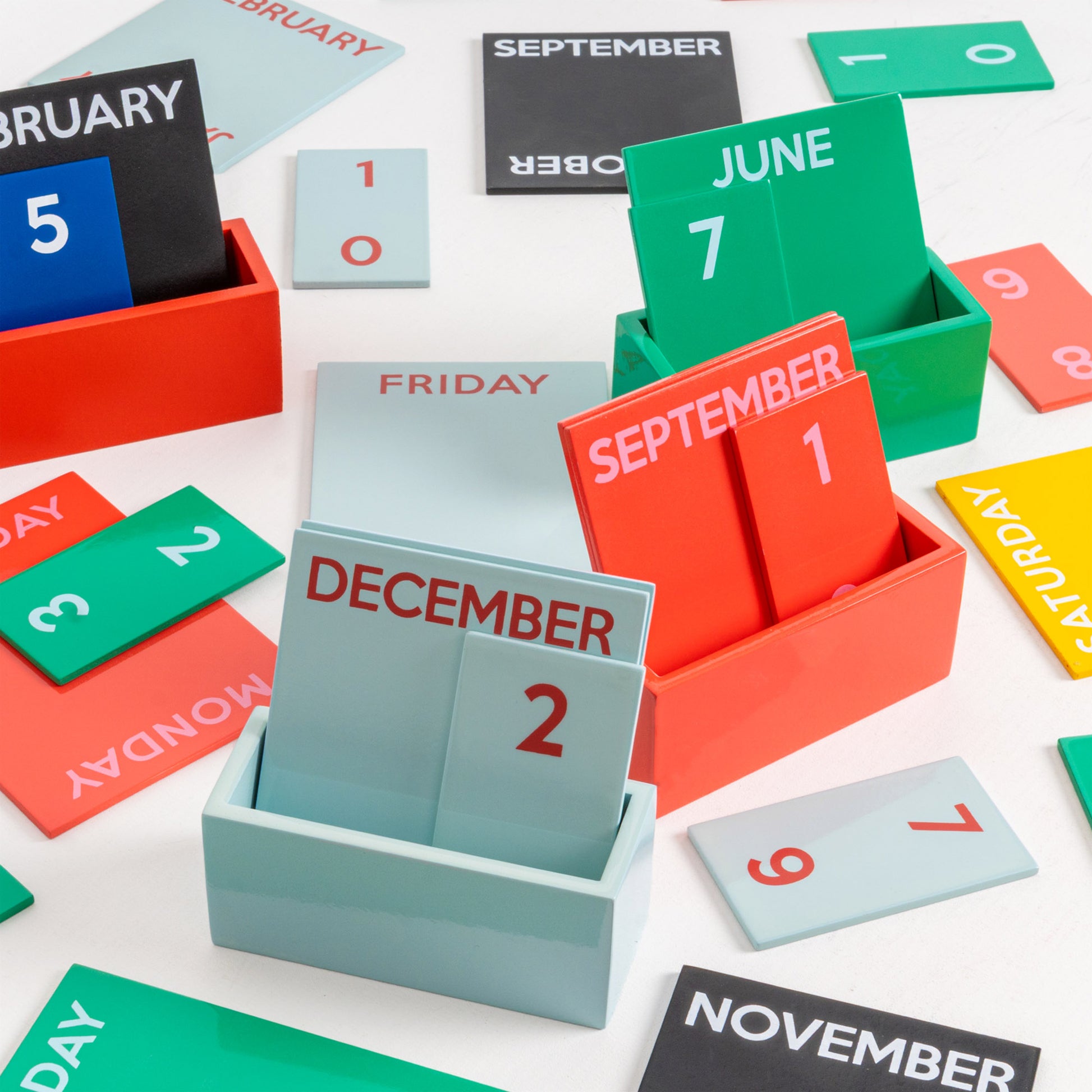 Colorful calendar cards in various boxes on a white background
