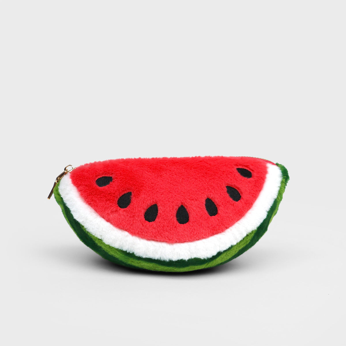 Plush Watermelon Zip Pouch - a plush watermelon slice pouch with a red body, green rind, white pith, and black seeds, shown on a light grey background.