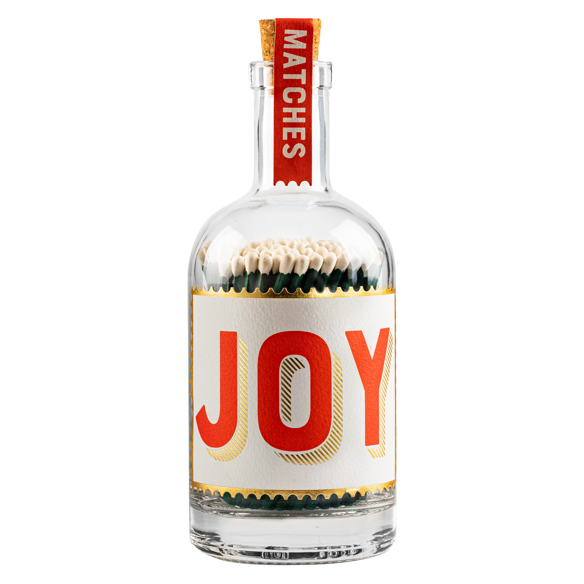 A clear glass bottle filled with matchsticks, featuring a white label with the word 'JOY' in large red letters outlined in gold, and a red neck tag reading 'MATCHES'.
