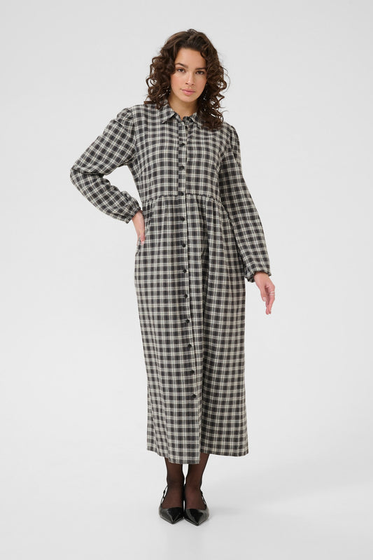 Woman wearing a black and white checkered dress on a white background