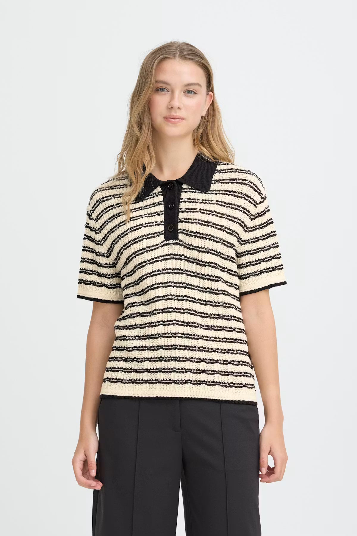 Woman wearing a striped shirt with a black collar on a white background
