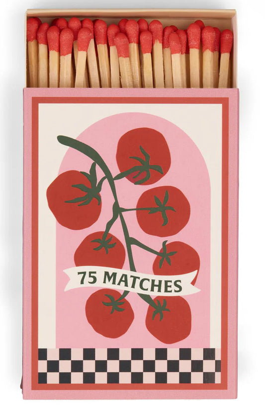 Matchbox with tomato design and '75 Matches' text on a pink background