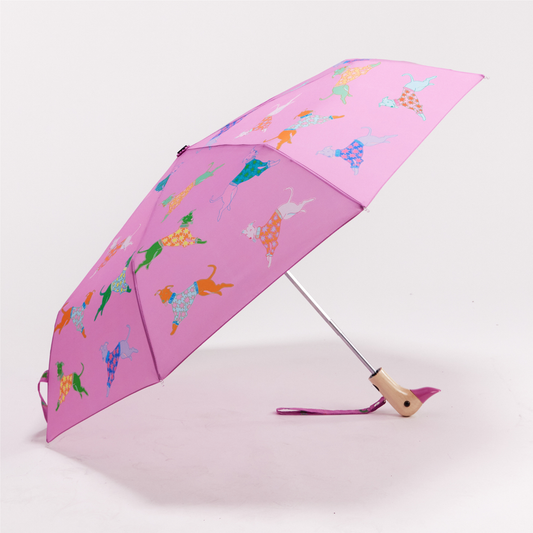 Original Duckhead Dogs in Pink Compact Duck Umbrella - a pink folding umbrella with a colourful pattern of leaping dogs, shown open on a light grey studio background.