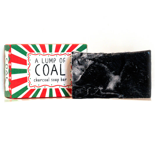 Charcoal soap bar with a colorful packaging labeled 'A Lump of Coal' on a white background