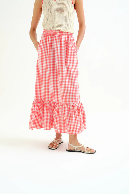 Person wearing a red and white checkered skirt on a white background