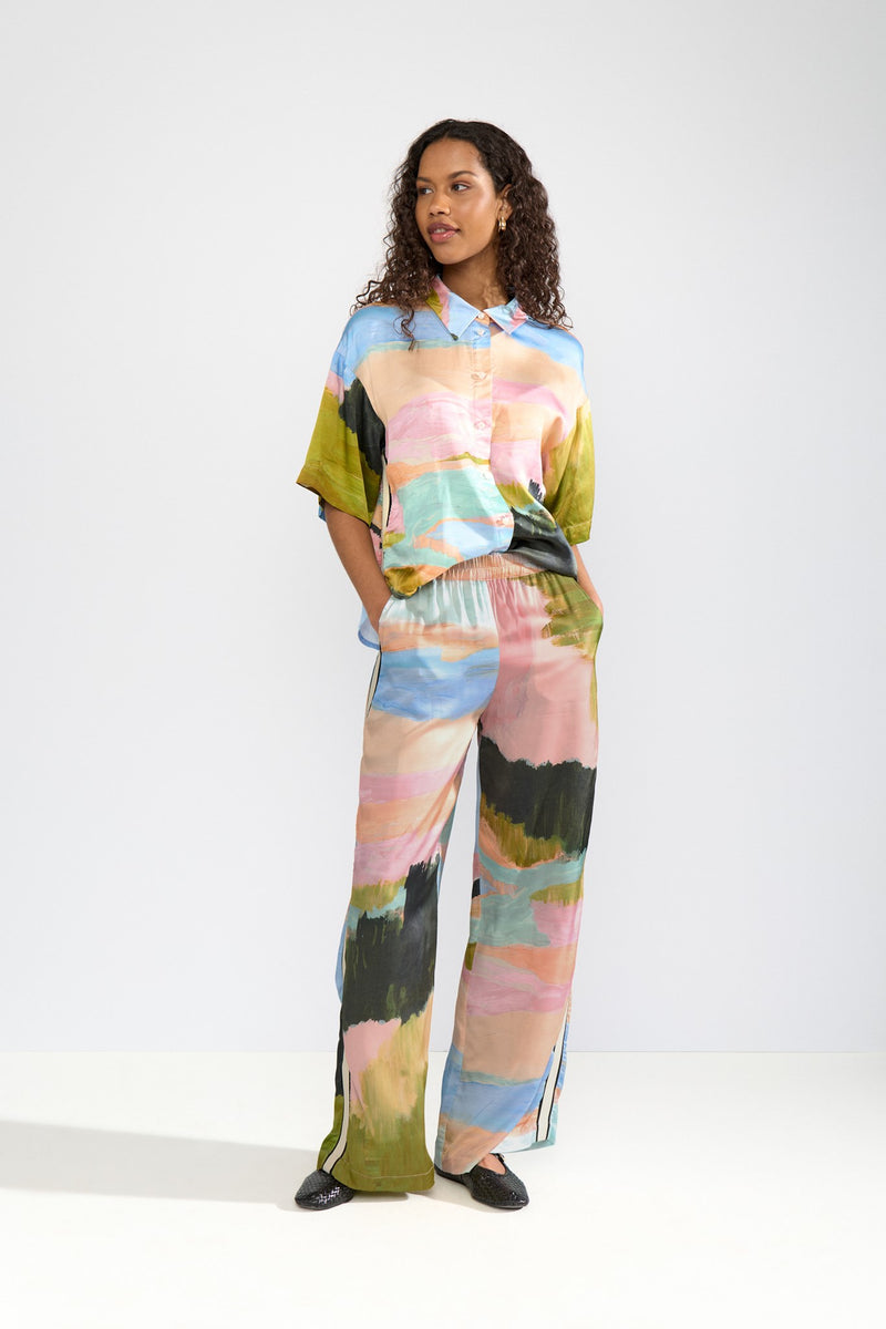 Woman wearing a colorful outfit with a white background
