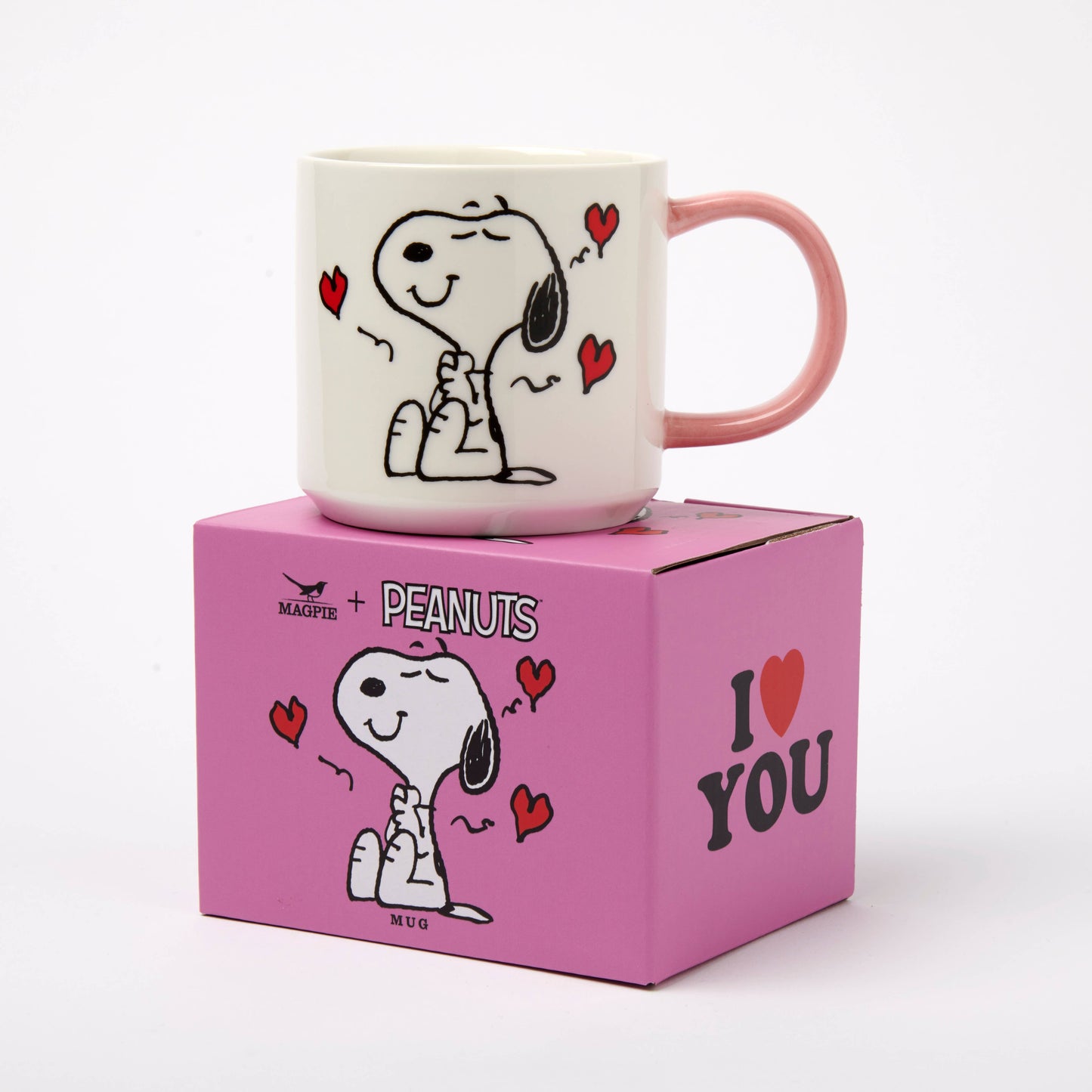Peanuts-themed mug on a pink box with cartoon character design