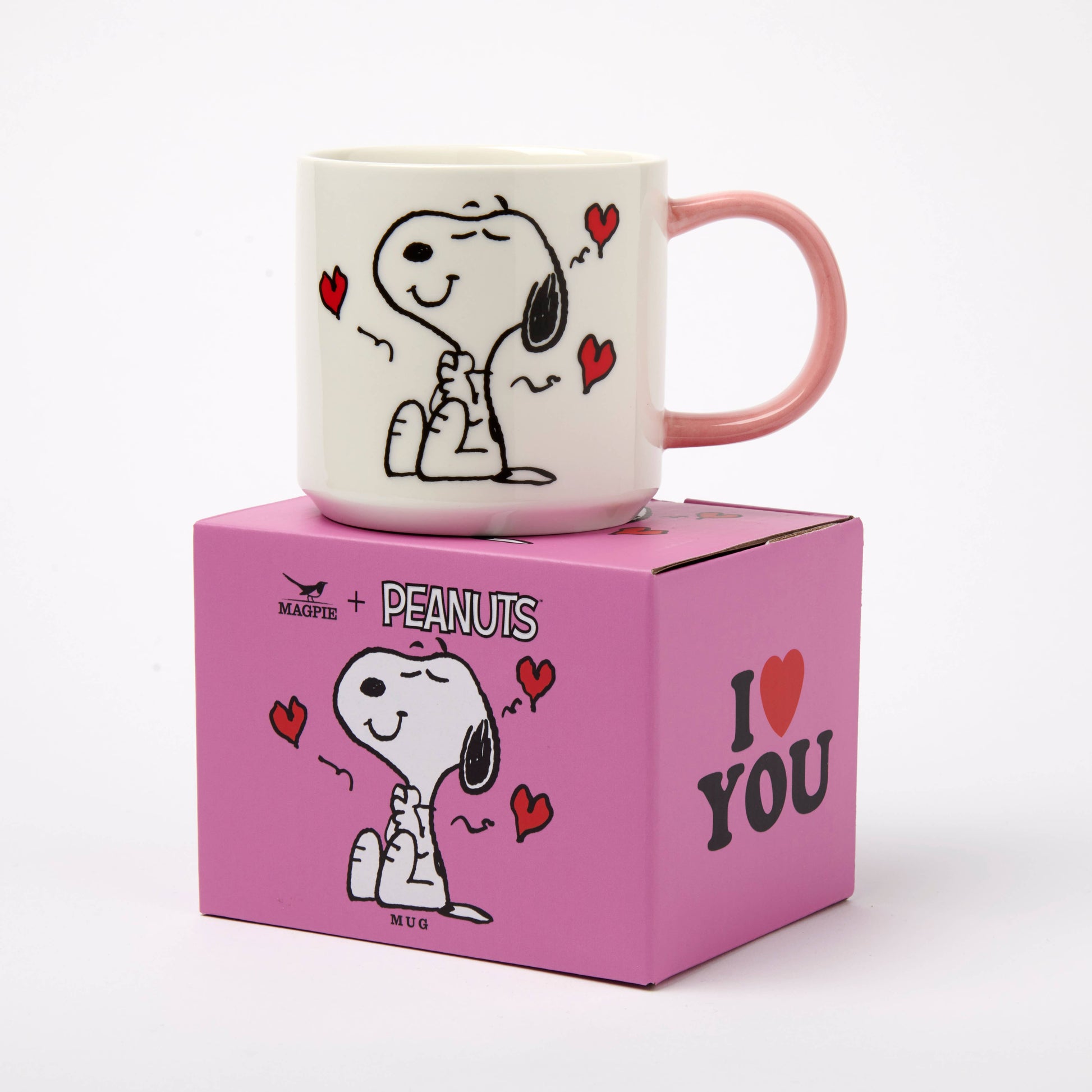 Peanuts-themed mug on a pink box with cartoon character design