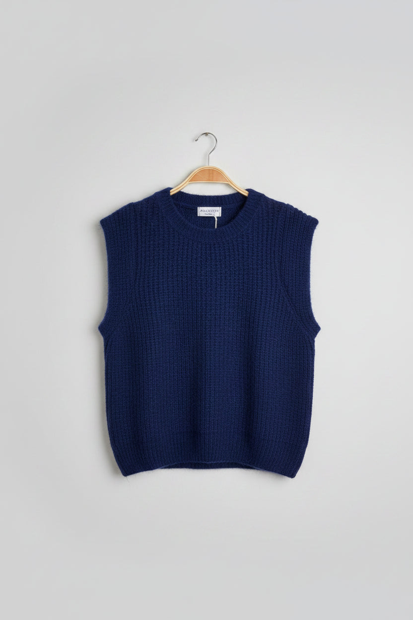 Blue sweater on a hanger with a visible tag on a grey background
