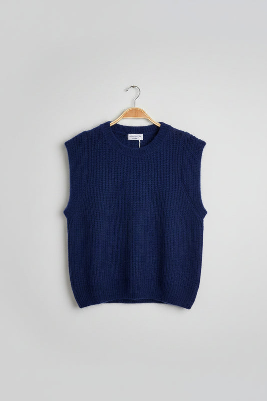 Blue sweater on a hanger with a visible tag on a grey background