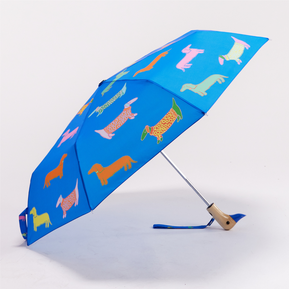 Original Duckhead Dogs in Blue Compact Duck Umbrella - Blue umbrella with colourful dog pattern on a white background and a wooden duck head handle