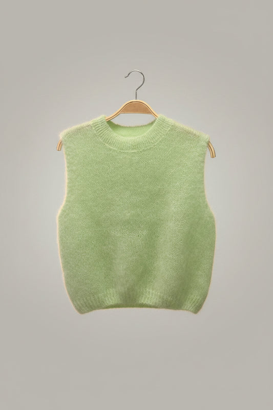 Light green sweater on a beige background