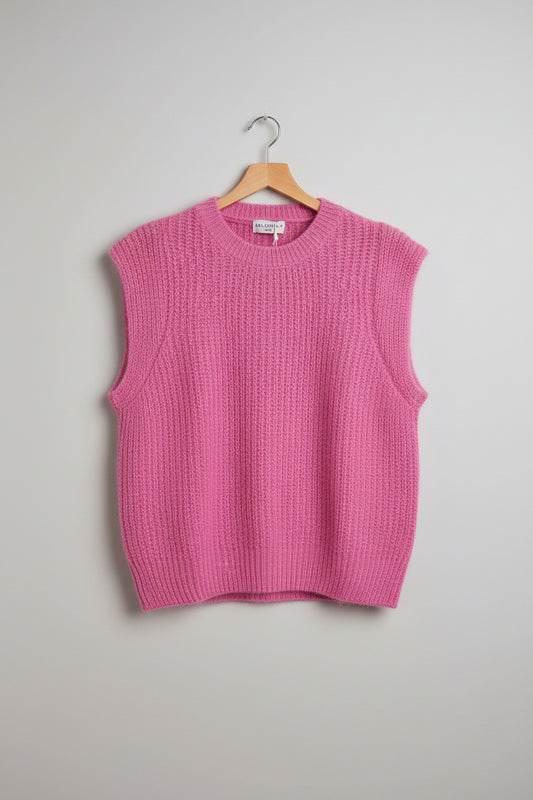 Pink sweater on a hanger on a grey background
