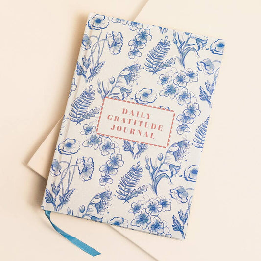 Daily Gratitude Journal with blue floral pattern on beige background