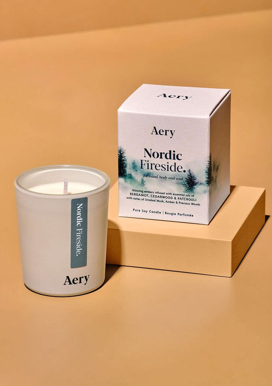 Aery candle and packaging on a beige background