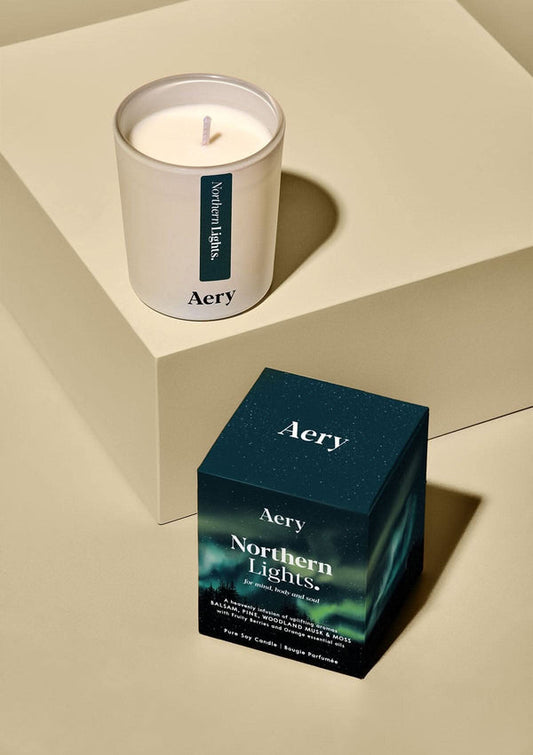 Aery candle and packaging on a beige surface