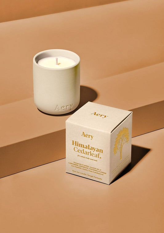 Aery Himalayan Cedarleaf Votive Candle. Aery candle and its packaging on a beige background