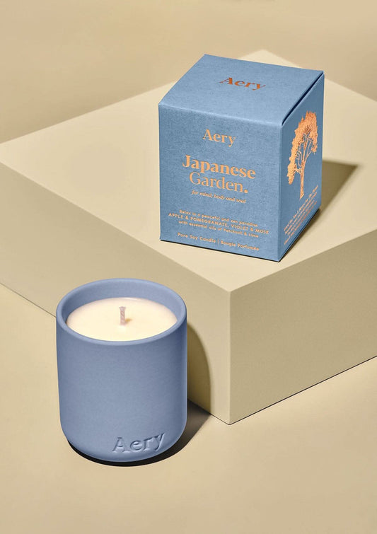 Aery Himalayan Japanese Garden Votive Candle 130g. Blue candle and box with 'Aery' branding on a beige background