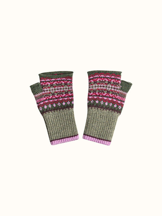 A pair of knit fingerless gloves in olive green with a colorful Fair Isle pattern in pink, red, and white, and a ribbed pink cuff, shown on a plain off-white background.