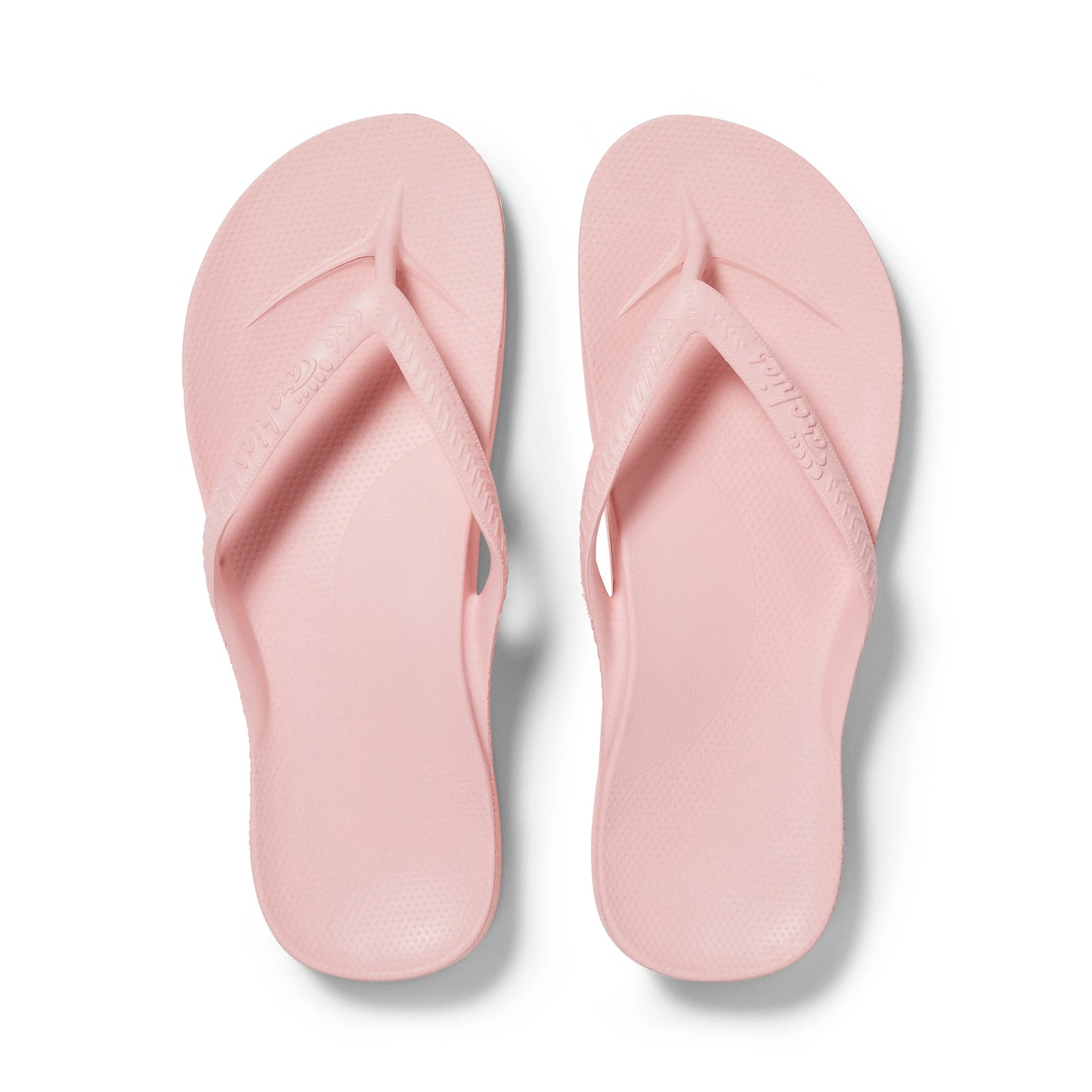 Pair of pink flip-flops on a white background