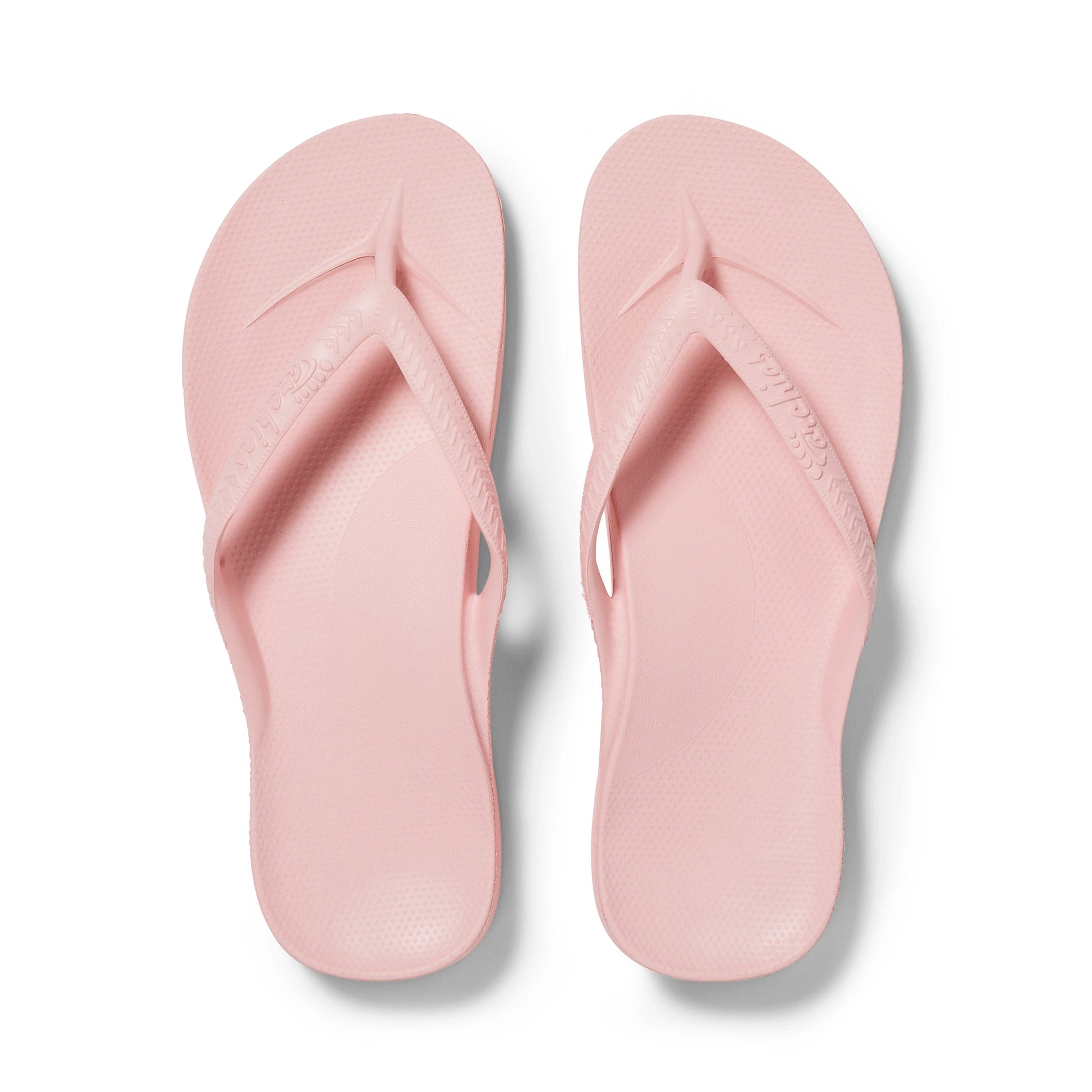 Pair of pink flip-flops on a white background