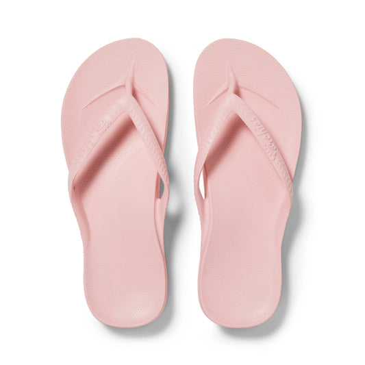 Pair of pink flip-flops on a white background