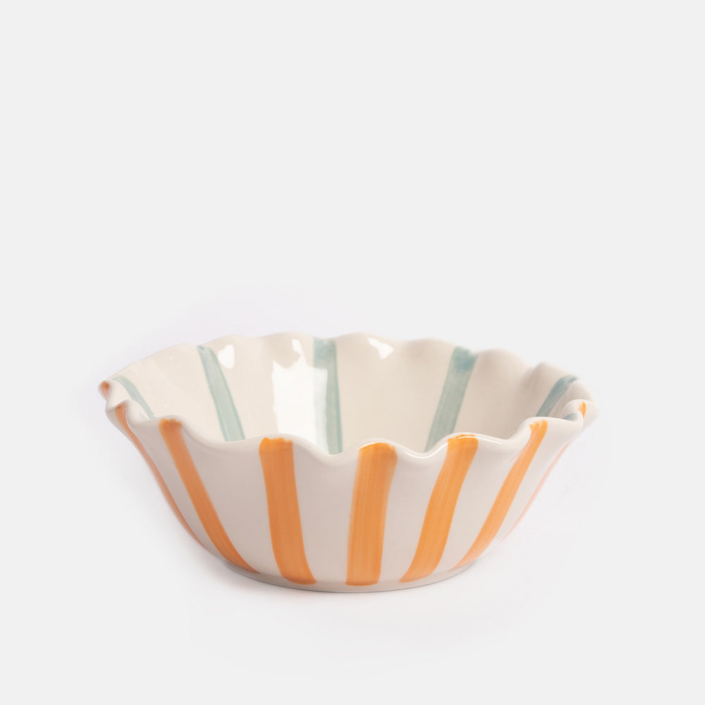 Ceramic bowl with orange and green stripes on a white background