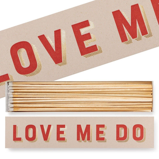 A box of long matches with 'LOVE ME DO' printed on it, the matches are displayed in a clear box with the sticks visible.