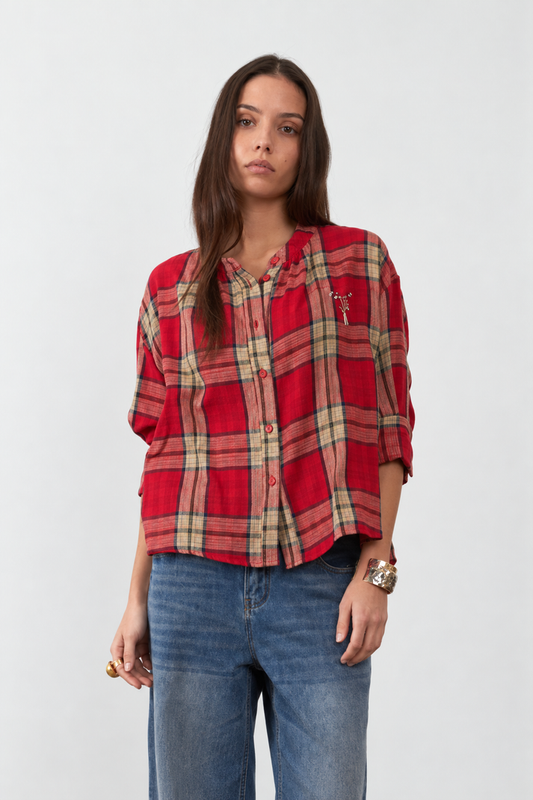 Orfeo Simone Blouse in Red checks - A woman modeling a red and beige plaid button-up shirt with blue jeans against a plain light grey background.