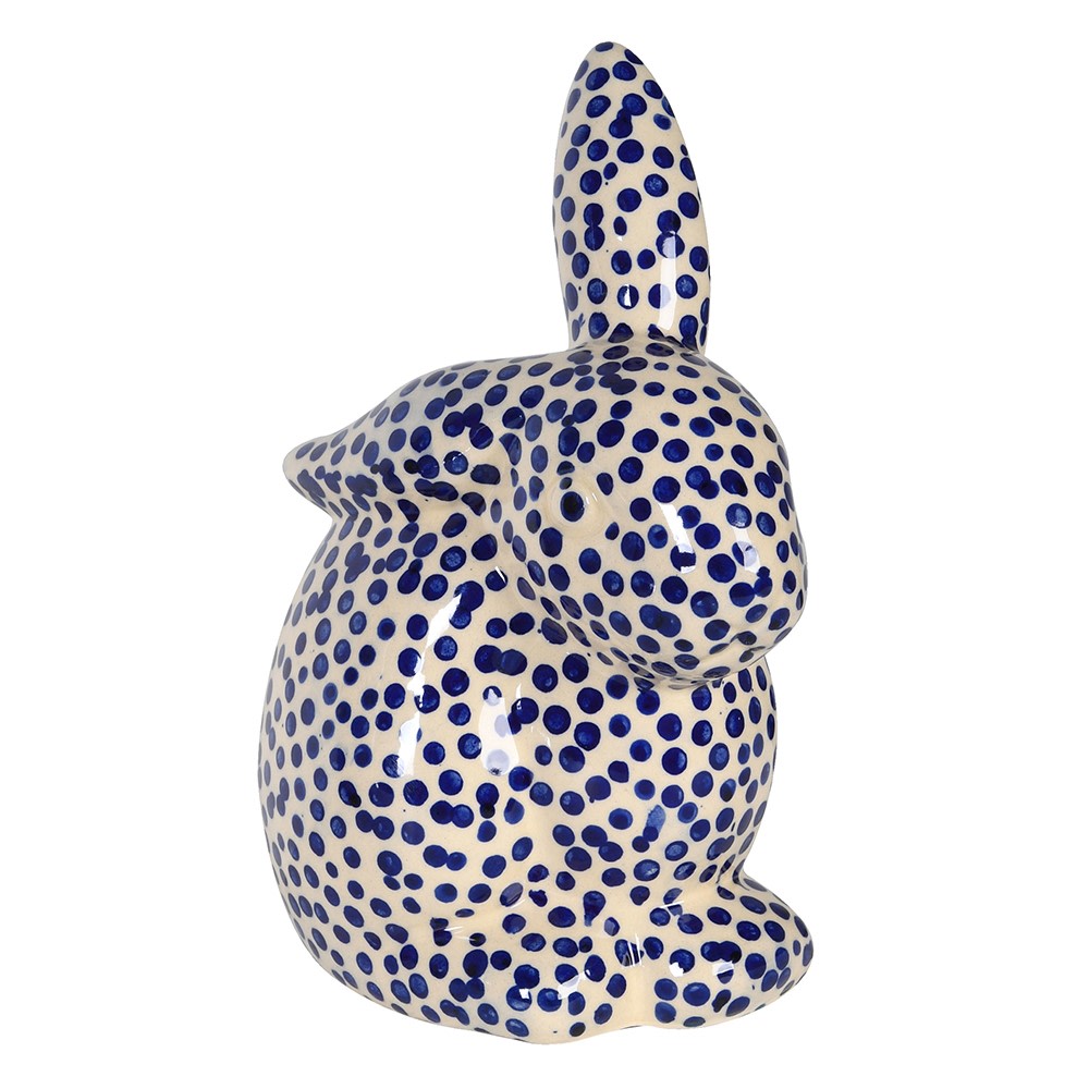 Ceramic rabbit figurine with blue and white polka dot pattern on a white background