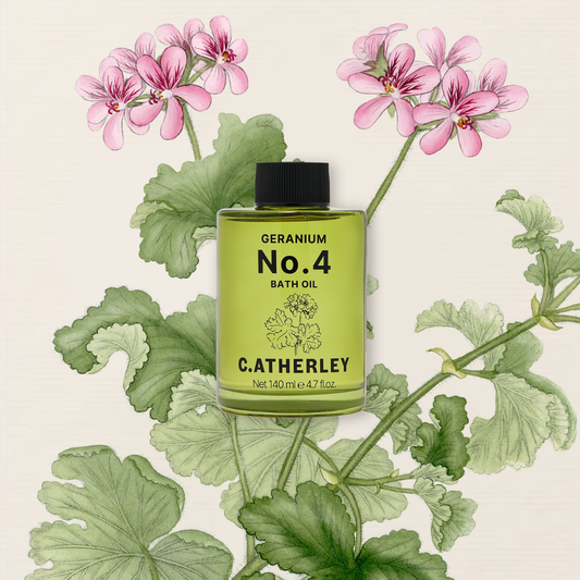 Catherley Geranium No.4 bath oil bottle with pink flowers and green leaves on a beige background