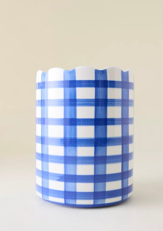 Blue and white checkered ceramic wine cooler on a beige background