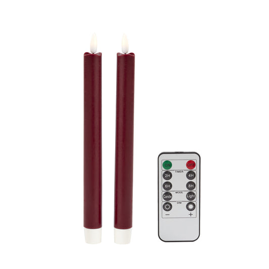 Two red LED candles with a remote control on a white background