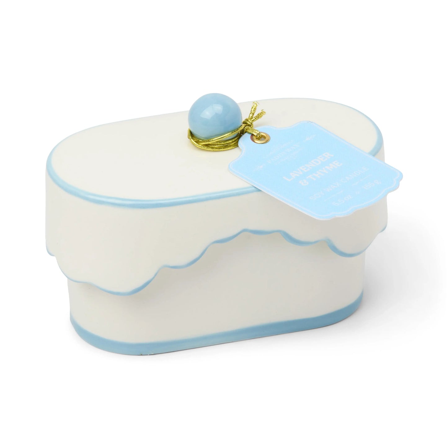 White toy cake with blue accents and a blue ball on top, on a white background