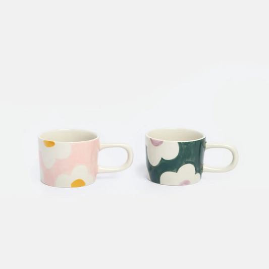 Two espresso cups with flowers on a white background