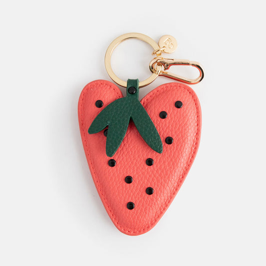 Caroline Gardner Red Strawberry Bag Charm. Strawberry-shaped keychain with a gold clasp on a light grey background