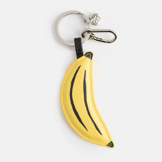Caroline Gardner Yellow Banana Bag Charm. Banana-shaped keychain on a white background